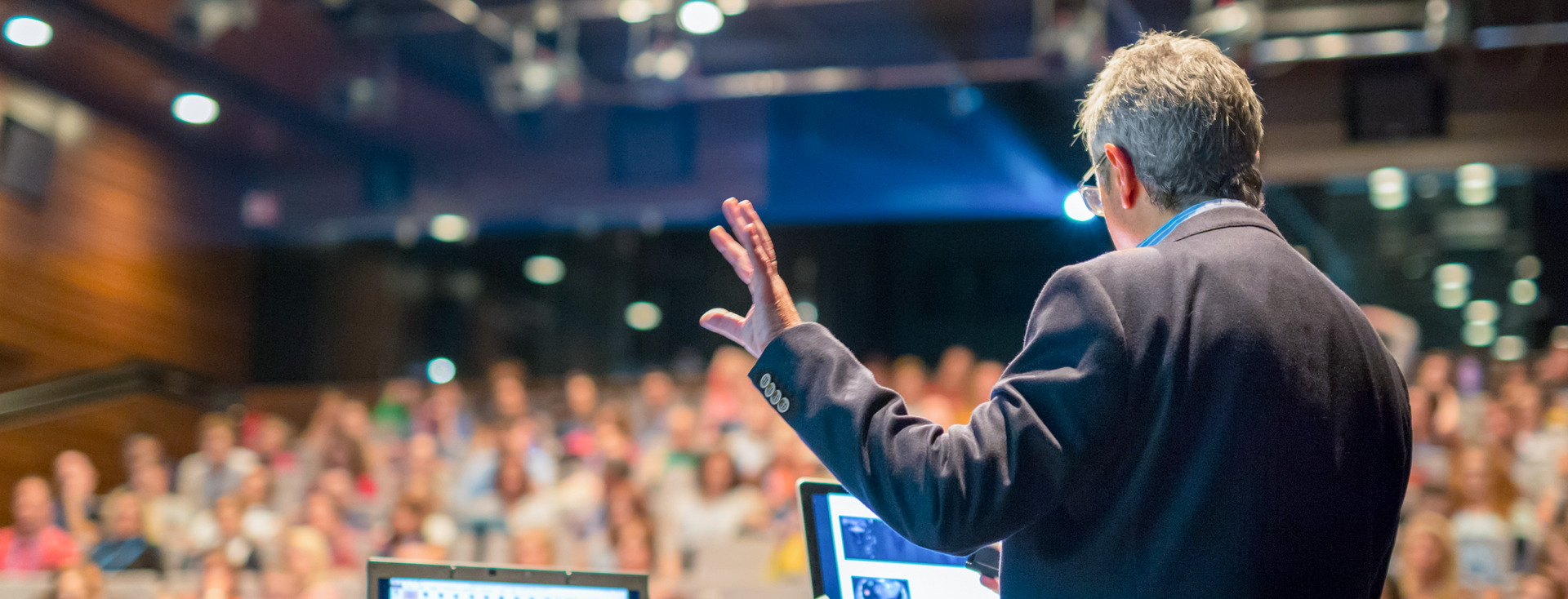 professor gives a speech in front of a large audience professor gives a speech in front of a large audience